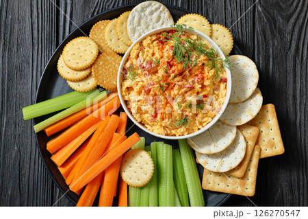pimento cheese dip served with crackers, veggies 126270547