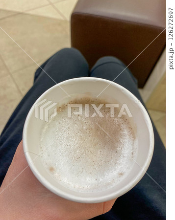 Man holding a paper cup with coffee, vertical picture 126272697