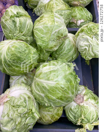 White cabbage lying on the counter at the store, vertical picture 126272758