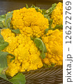 A yellow cauliflower lies on the counter in a store for sale, vertical picture 126272769