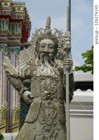 Chinese guardian statue at the gate of Wat Pho Which is one of the largest and oldest temples in Bangkok and is popular with both Thai and foreign tourists. 126274145