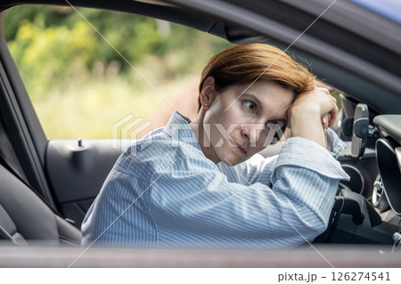 Tired fatigue woman driving car having problems on road waiting in traffic jam. Tired fatigue woman driving car having problems on road waiting in traffic jam. 126274541