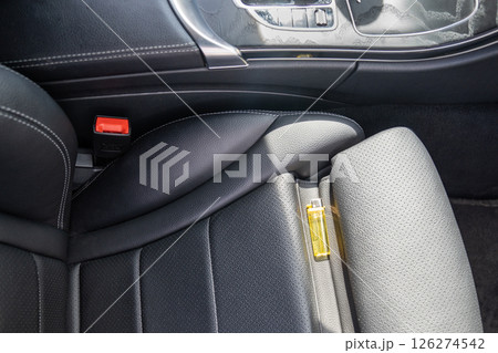 Forgotten gas lighter in car on seat, which can lead to fire in sunny hot weather. Forgotten gas lighter in car on seat, which can lead to fire in sunny hot weather. 126274542