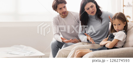 Naughty Kid. Annoyed Parents Scolding Their Little Daughter For Her Behaviour While Sitting Together On Couch At Home Naughty Kid. Annoyed Parents Scolding Their Little Daughter For Her Behaviour While Sitting Together On Couch At Home 126274593