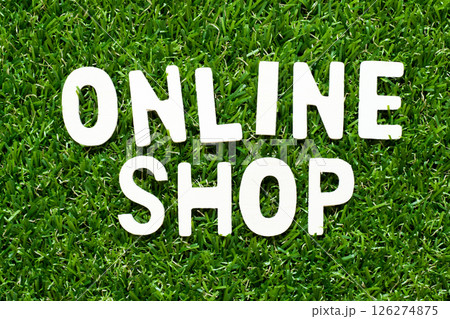 Wood alphabet letter in word online shop on green grass background Wood alphabet letter in word online shop on green grass background 126274875
