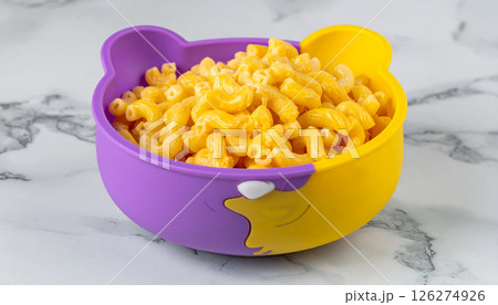 A bear-shaped bowl filled with creamy macaroni and cheese, a fun meal for kids. 126274926