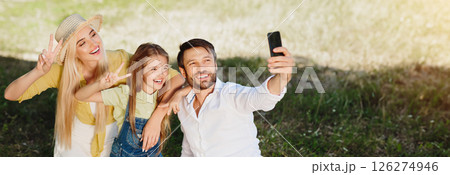 Cheerful family making selfie outdoors in park, having picnic at weekends Cheerful family making selfie outdoors in park, having picnic at weekends 126274946