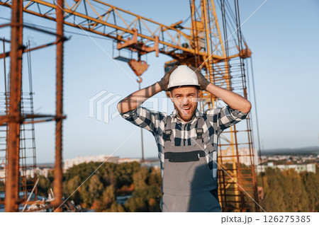 Angry man is working on the construction site at daytime 126275385