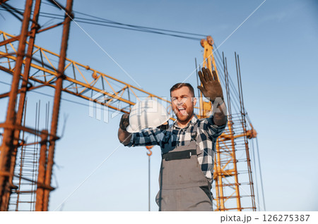 Angry man is working on the construction site at daytime Angry man is working on the construction site at daytime 126275387