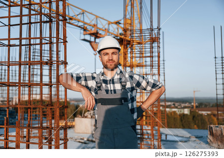 Front view of man that is working on the construction site at daytime 126275393