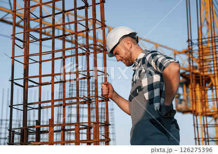Feeling bad. Having headache. Man is working on the construction site at daytime Feeling bad. Having headache. Man is working on the construction site at daytime 126275396
