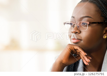 Closeup portrait of confident african american businesswoman in glasses looking aside with ambitious face expression, copy space 126275791