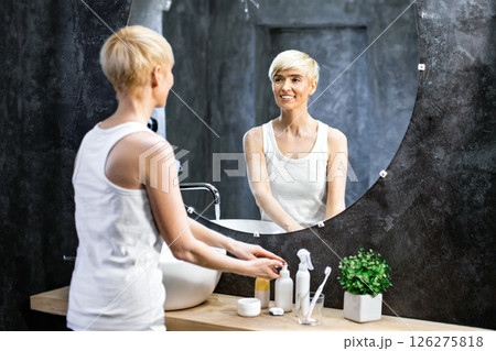 Middle-Aged Woman Washing Hands Standing In Bathroom. Hygiene And Skincare. Panorama, Copy Space, Selective Focus Middle-Aged Woman Washing Hands Standing In Bathroom. Hygiene And Skincare. Panorama, Copy Space, Selective Focus 126275818