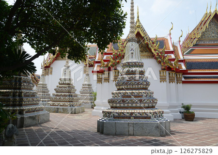 Classic Thai architecture with pagoda in Wat Phra Chetuphon or Wat Pho. Which is one of the largest and oldest temples and is popular with both Thai and foreign tourists. Classic Thai architecture with pagoda in Wat Phra Chetuphon or Wat Pho. Which is one of the largest and oldest temples and is popular with both Thai and foreign tourists. 126275829