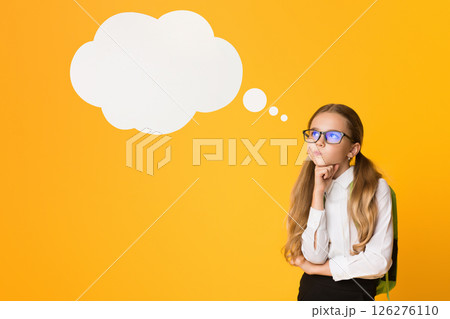 Thoughtful Elementary Schoolgirl Thinking Standing Over Yellow Background In Studio. Free Space For Text Thoughtful Elementary Schoolgirl Thinking Standing Over Yellow Background In Studio. Free Space For Text 126276110