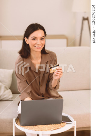 Online Shopping. Happy Girl Using Laptop And Credit Card Buying Things From Home, Looking At Camera, Copyspace Online Shopping. Happy Girl Using Laptop And Credit Card Buying Things From Home, Looking At Camera, Copyspace 126276214