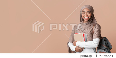 Education For Islamic People Concept. Portrait Of Happy Afro Muslim Woman In Headscarf With Backpack And Notepads Over Yellow Background, Copy Space 126276224