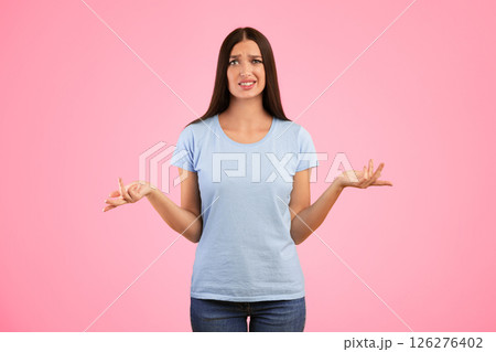 Who Knows. Portrait Of Confused Woman Shrugging Shoulders, Spreading Hands, Looking At Camera Posing Over Yellow Background. Studio Shot. Puzzled lady is clueless. I'm sorry, exuse me, can't decide Who Knows. Portrait Of Confused Woman Shrugging Shoulders, Spreading Hands, Looking At Camera Posing Over Yellow Background. Studio Shot. Puzzled lady is clueless. I'm sorry, exuse me, can't decide 126276402