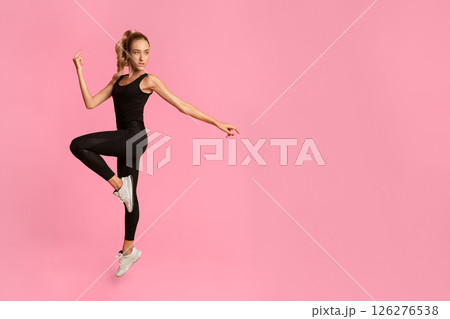 Fit Lady Jumping Exercising During Workout Over Yellow Background. Studio Shot, Full Length Fit Lady Jumping Exercising During Workout Over Yellow Background. Studio Shot, Full Length 126276538