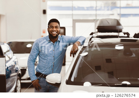 Car Buyer. Happy Afro Man Standing Posing Near New Auto In Dealership Store. Copy Space 126276574