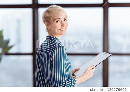 Documents For Business. Smiling Lady Holding Folder With Papers Standing In Modern Office. Selective Focus Documents For Business. Smiling Lady Holding Folder With Papers Standing In Modern Office. Selective Focus 126276661