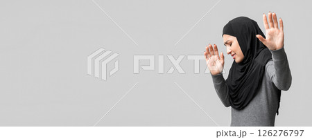 Domestic Violence Among Muslim Women. Afraid islamic girl gesturing stop with open palms, trying to protect herself from abuse, grey background Domestic Violence Among Muslim Women. Afraid islamic girl gesturing stop with open palms, trying to protect herself from abuse, grey background 126276797