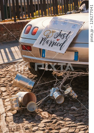 Cans attached to the back of a car to celebrate a wedding 126277041