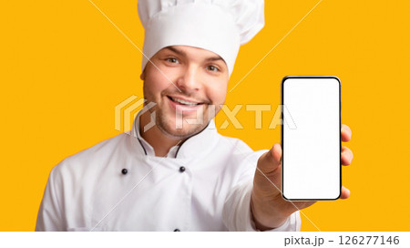 Food Delivery App. Chef Man Showing Phone With Blank Screen Recommending Catering Service Standing On Yellow Studio Background. Panorama Food Delivery App. Chef Man Showing Phone With Blank Screen Recommending Catering Service Standing On Yellow Studio Background. Panorama 126277146