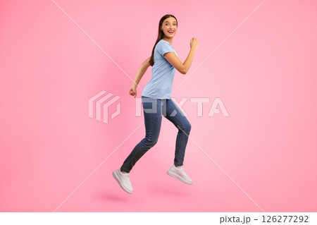 Hurry Up. Excited young woman in casual clothes running towards copy space for advertisement isolated over yellow studio background. Shocked lady jumping and looking at camera, full length shot Hurry Up. Excited young woman in casual clothes running towards copy space for advertisement isolated over yellow studio background. Shocked lady jumping and looking at camera, full length shot 126277292