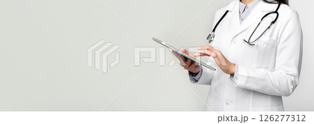 Medical Devices. Unrecognizable Doctor Using Digital Tablet Standing In Studio On White Background. Cropped 126277312