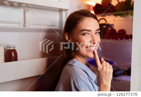 Its our secret. Tricky girl opening fridge late, gesturing shh on camera, free space 126277376