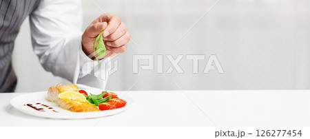 Unrecognizable Male Chef Cooking And Plating Fish Dish, Decorating Salmon Steak With Herbs Standing In Kitchen. Cropped, Selective Focus Unrecognizable Male Chef Cooking And Plating Fish Dish, Decorating Salmon Steak With Herbs Standing In Kitchen. Cropped, Selective Focus 126277454
