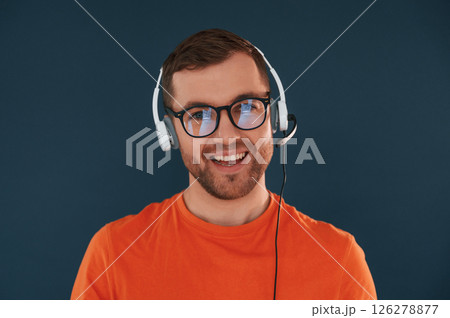 Handsome man is in the studio against blue background 126278877