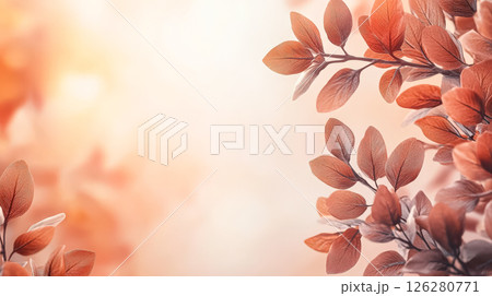 Leafy tree branch with a light orange background 126280771