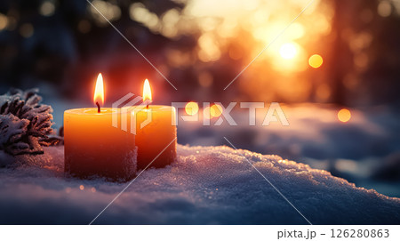 Two candles are lit on a snowy ground 126280863