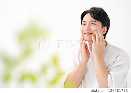 笑顔で頬を触る男性 126281738