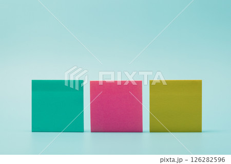 Colorful Post-it Notes Arranged on a Blue Background Colorful Post-it Notes Arranged on a Blue Background 126282596