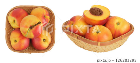 Ripe nectarine fruit in a wicker basket isolated on white background. Top view. Flat lay 126283295