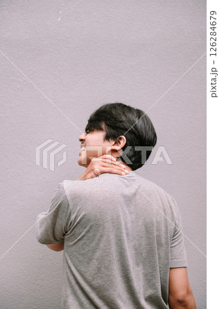 young man suffering from neck pain young man suffering from neck pain 126284679