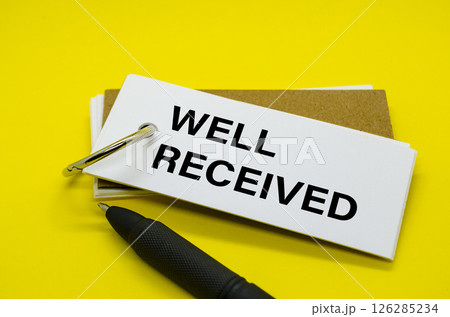 Well Received Text on white notepad with yellow cover background Well Received Text on white notepad with yellow cover background 126285234