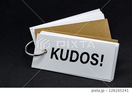 KUDOS text on white notepad. A Simple Gesture, A Powerful Message of Recognition and Encouragement KUDOS text on white notepad. A Simple Gesture, A Powerful Message of Recognition and Encouragement 126285241