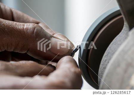 The small drill tool regrind process by manual operation with abrasive wheel. 126285617