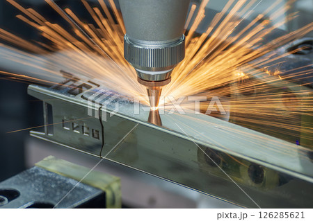 Close up scene the fiber laser cutting machine cut the square shape stainless steel tube with sparkling light. Close up scene the fiber laser cutting machine cut the square shape stainless steel tube with sparkling light. 126285621
