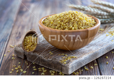 Bowl of Bulgur Wheat on Rustic Table. 126287214
