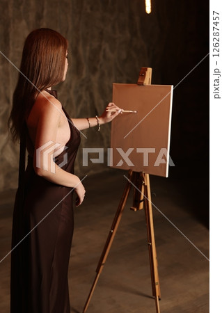 Artistic Expression A Woman Engaged in the Process of Painting in a Studio Setting 126287457