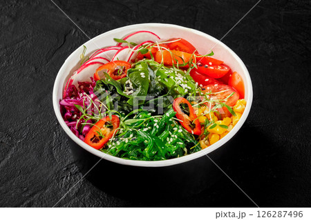 Colorful vegan poke bowl with corn, chuka seaweed, tomatoes and radishes Colorful vegan poke bowl with corn, chuka seaweed, tomatoes and radishes 126287496