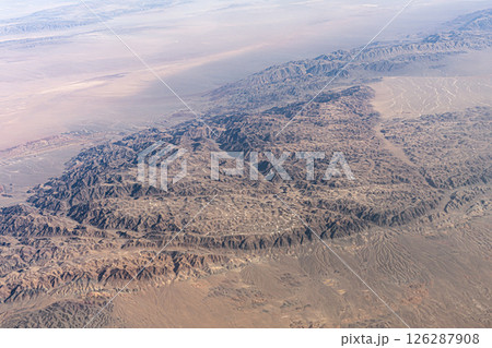 The Tangla Mountain range in the Tibetan Plateau in China, opening from an airplane window during flight. 126287908