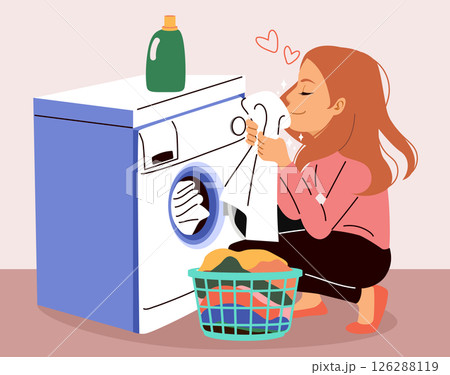 Housewife Woman Sitting Near Washing Machine Inhaling fragrant freshly washed towel after using good laundry detergent 126288119