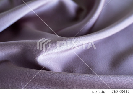 Soft lilac fabric with flowing folds and subtle elegant texture Soft lilac fabric with flowing folds and subtle elegant texture 126288437