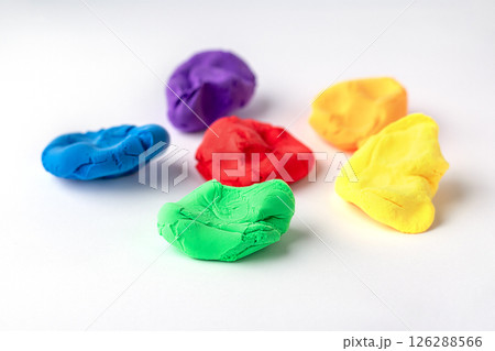 Colorful modeling clay pieces arranged on a white background 126288566
